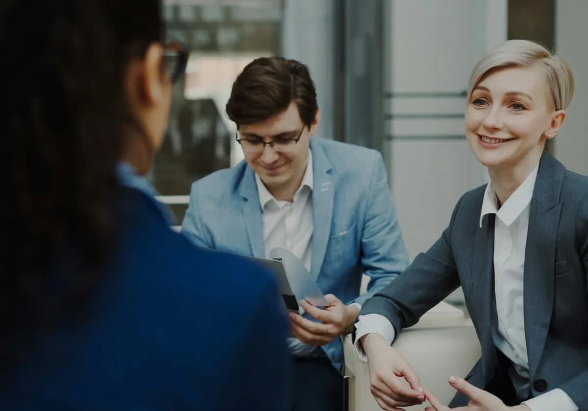 Business partners discussing a proposal in a modern office meeting area
